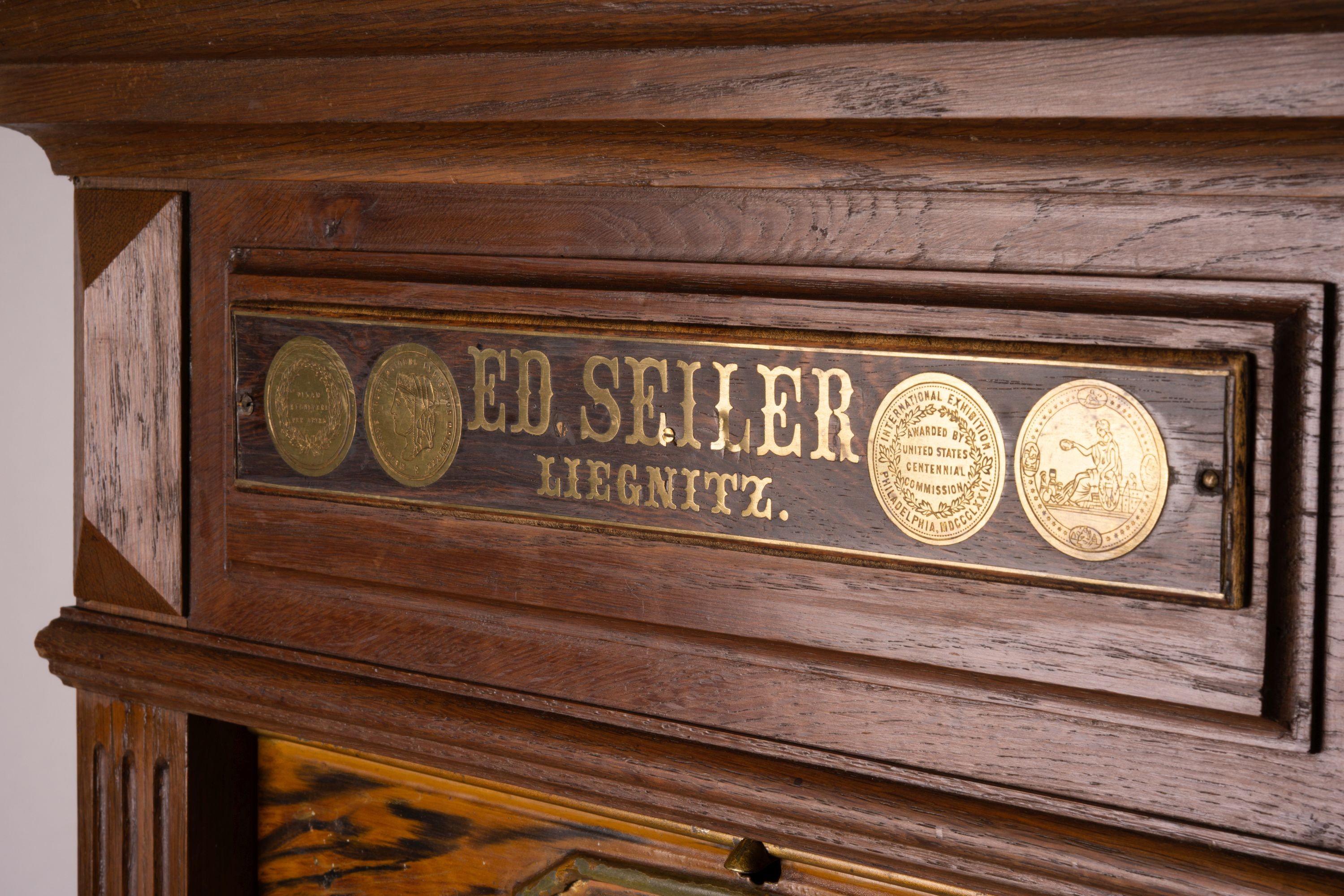 A late 19th / early 20th century oak and simulated walnut shop storage chest / filing cabinet, labelled Ed Seiler, width 57cm, depth 34cm, height 152cm